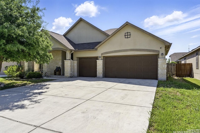 ranch-style house featuring an attached garage, concrete driveway, stucco siding, and stone siding