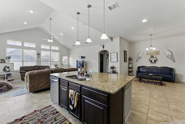 kitchen featuring visible vents, arched walkways, a sink, open floor plan, and ceiling fan with notable chandelier