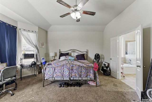 carpeted bedroom with ensuite bathroom, a ceiling fan, and vaulted ceiling