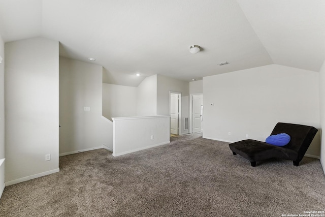 sitting room with an upstairs landing, carpet floors, and lofted ceiling
