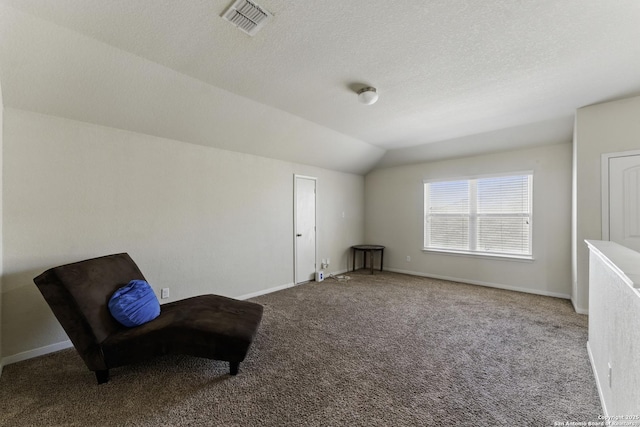 living area with visible vents, baseboards, vaulted ceiling, and carpet floors