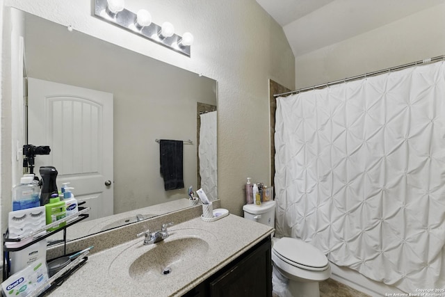 full bathroom with vanity, vaulted ceiling, a textured wall, a shower with curtain, and toilet