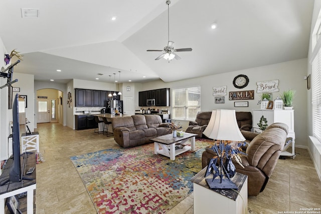 living room with visible vents, ceiling fan, arched walkways, and vaulted ceiling