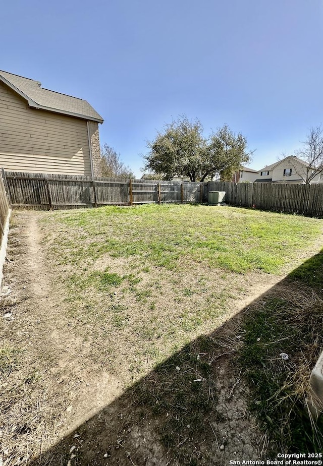 view of yard with a fenced backyard