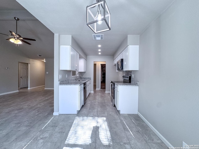 kitchen with baseboards, a sink, visible vents, and stainless steel appliances