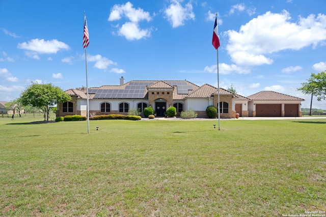 mediterranean / spanish house with a tile roof, a garage, and a front lawn