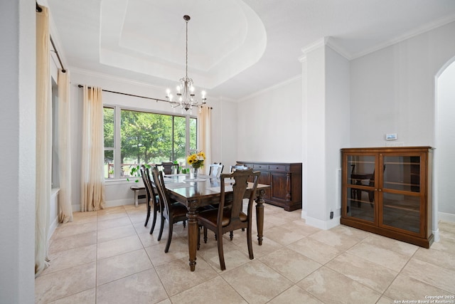 dining area featuring baseboards, arched walkways, a notable chandelier, a tray ceiling, and light tile patterned flooring
