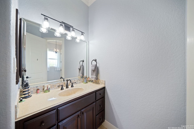 bathroom with a textured wall and vanity