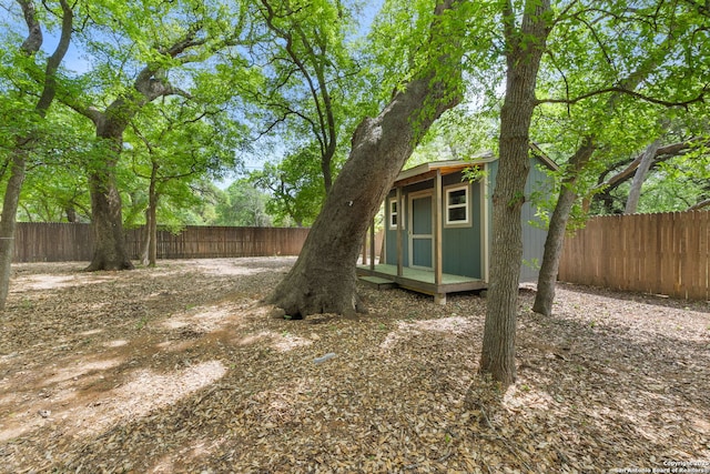 view of yard with a fenced backyard and an outdoor structure