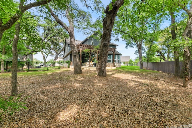 view of yard featuring a pergola and fence