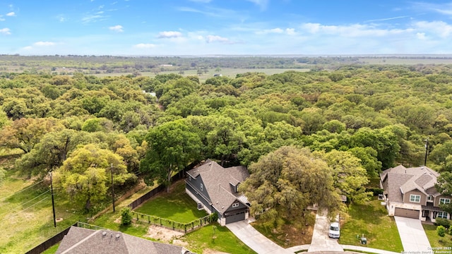 birds eye view of property with a view of trees