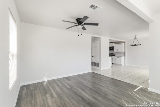 243 Alicia Ave, San Antonio, TX 78228 - unfurnished living room featuring visible vents, baseboards, ceiling fan, and a wealth of natural light