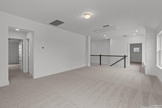 unfurnished room featuring light carpet, baseboards, visible vents, and recessed lighting