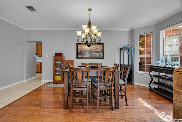 8114 Pimlico Ln, Boerne, TX 78015 - dining space with crown molding, an inviting chandelier, baseboards, and visible vents