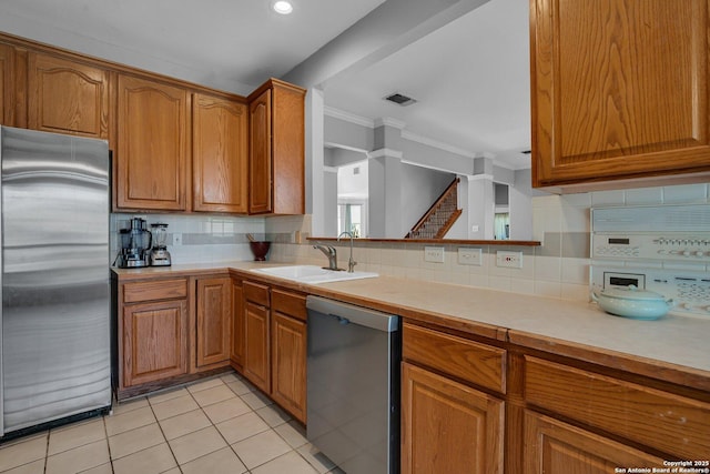 8114 Pimlico Ln, Boerne, TX 78015 - kitchen with visible vents, a sink, light countertops, appliances with stainless steel finishes, and brown cabinets