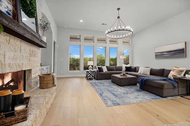 1064 Spanish Trl, New Braunfels, TX 78132 - living area featuring a stone fireplace, an inviting chandelier, recessed lighting, visible vents, and wood-type flooring