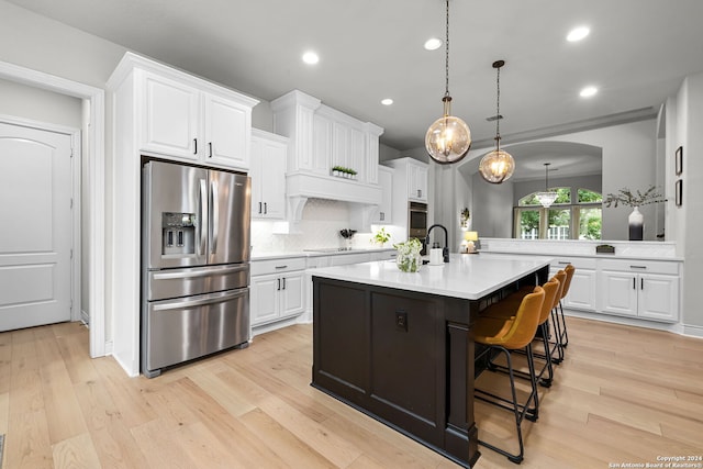 1064 Spanish Trl, New Braunfels, TX 78132 - kitchen with light countertops, recessed lighting, light wood-style floors, and stainless steel appliances