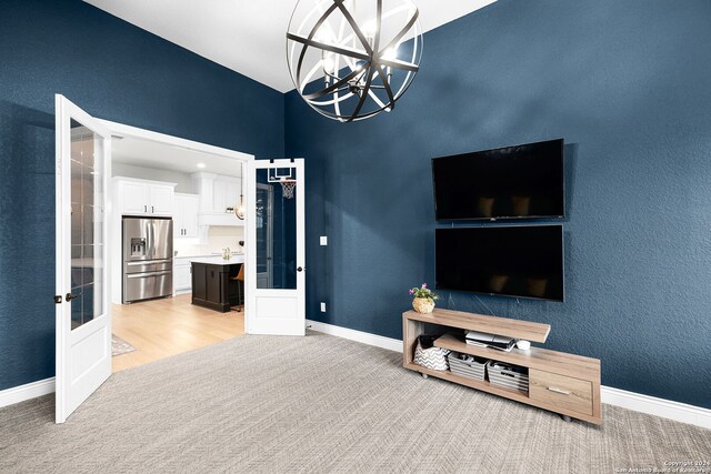 1064 Spanish Trl, New Braunfels, TX 78132 - living room with french doors, baseboards, a chandelier, and light carpet