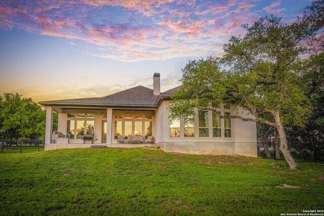 1064 Spanish Trl, New Braunfels, TX 78132 - back of property featuring a chimney, a patio area, fence, and a lawn