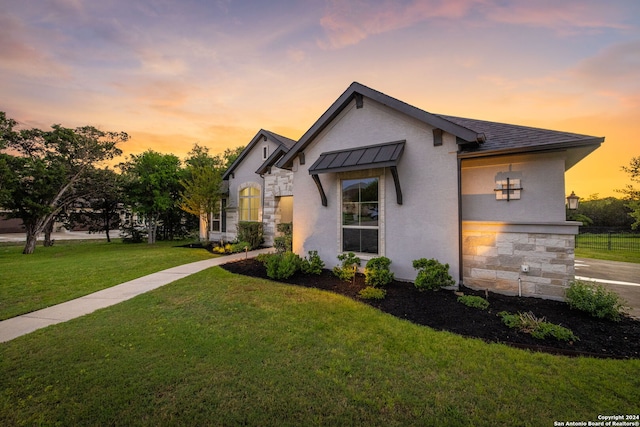 1064 Spanish Trl, New Braunfels, TX 78132 - view of front of home with stucco siding, stone siding, and a front lawn