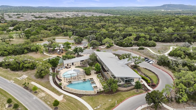 bird's eye view with a wooded view
