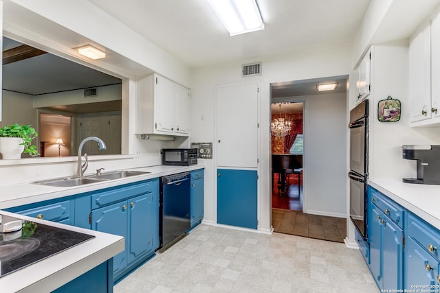 kitchen with visible vents, a sink, blue cabinetry, and black appliances