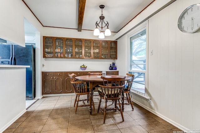 dining space featuring light tile patterned flooring, beamed ceiling, and plenty of natural light