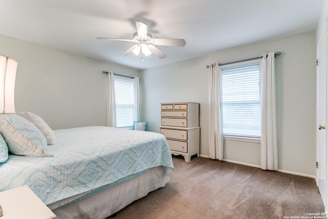 carpeted bedroom with baseboards and ceiling fan