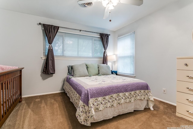 bedroom featuring ceiling fan, carpet floors, visible vents, and baseboards