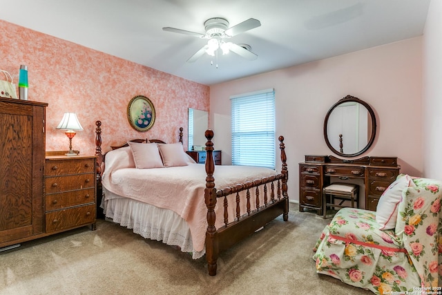 carpeted bedroom with wallpapered walls, a ceiling fan, and baseboards