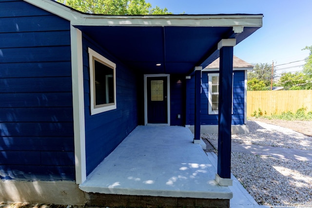 view of exterior entry featuring fence