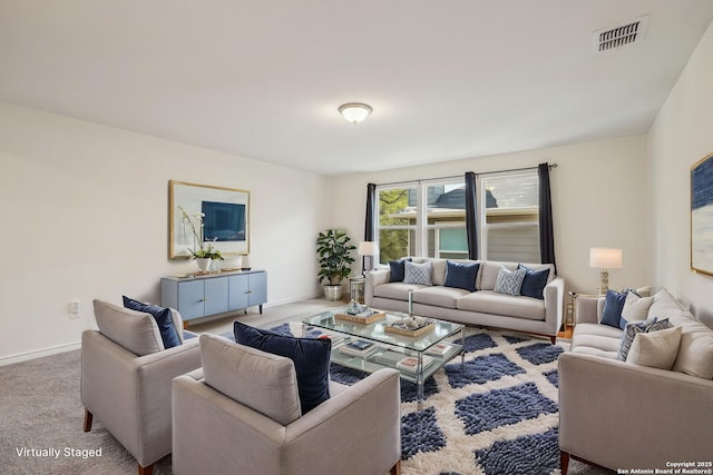 living room with visible vents, baseboards, and carpet