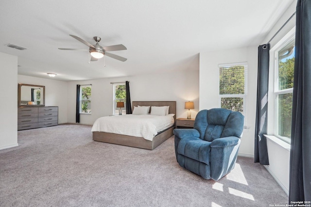 carpeted bedroom featuring visible vents and ceiling fan