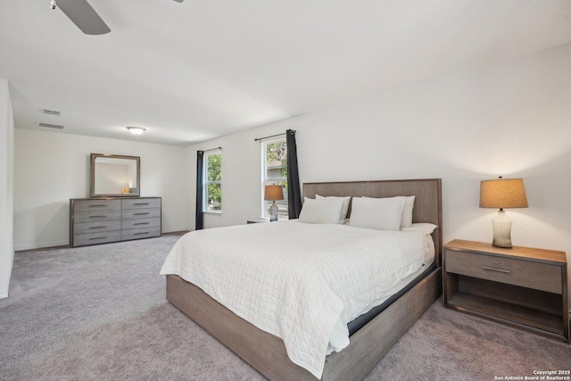 carpeted bedroom with visible vents and ceiling fan