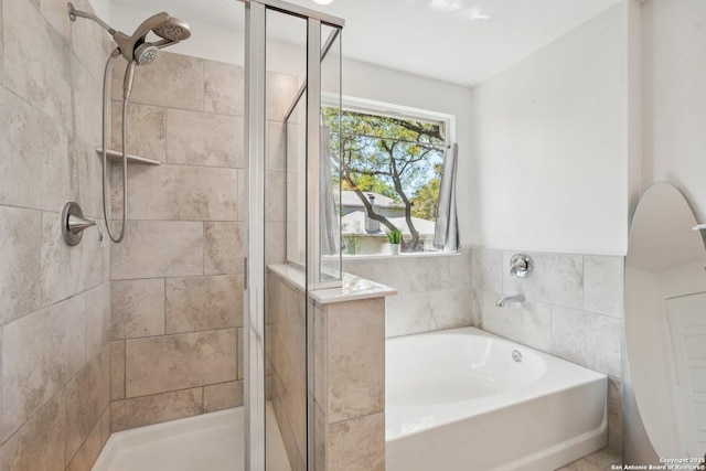 full bathroom featuring a stall shower and a garden tub