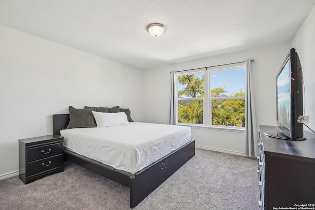 bedroom with carpet floors and baseboards