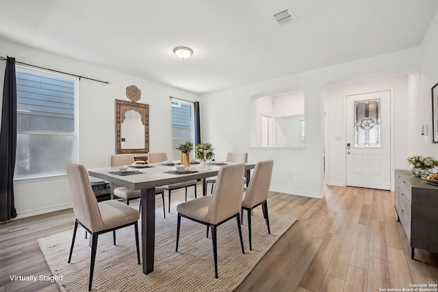 dining space featuring visible vents, baseboards, plenty of natural light, and light wood-style floors