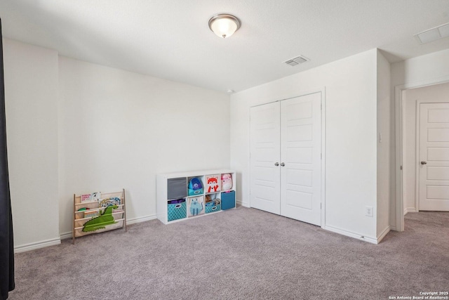 playroom featuring carpet flooring, baseboards, and visible vents