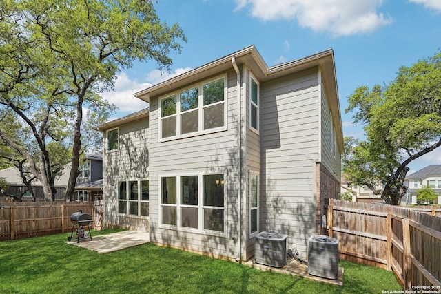 rear view of property with a patio area, a fenced backyard, cooling unit, and a lawn