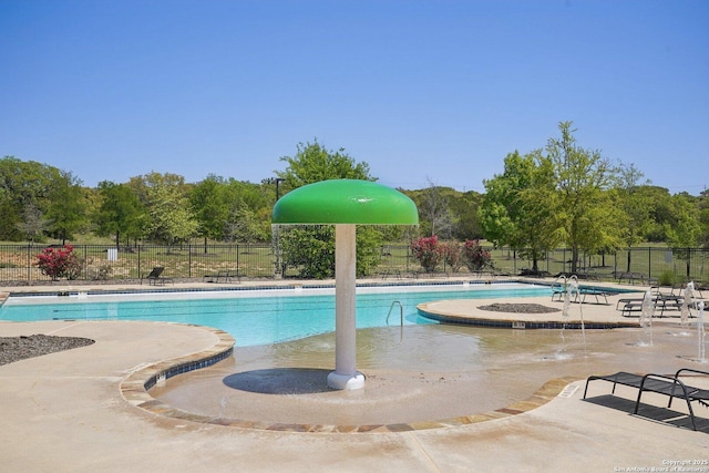 pool with a patio and fence