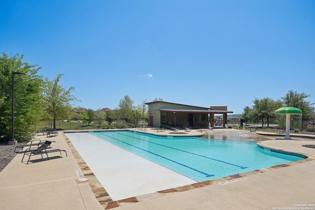 community pool featuring a patio area and fence