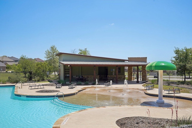 pool with a patio area and fence