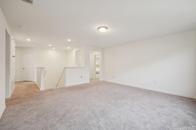 interior space with baseboards, recessed lighting, and light colored carpet
