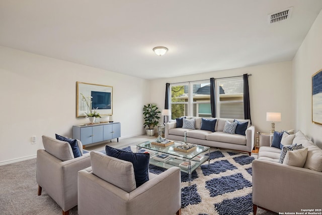 living area featuring visible vents, baseboards, and carpet floors