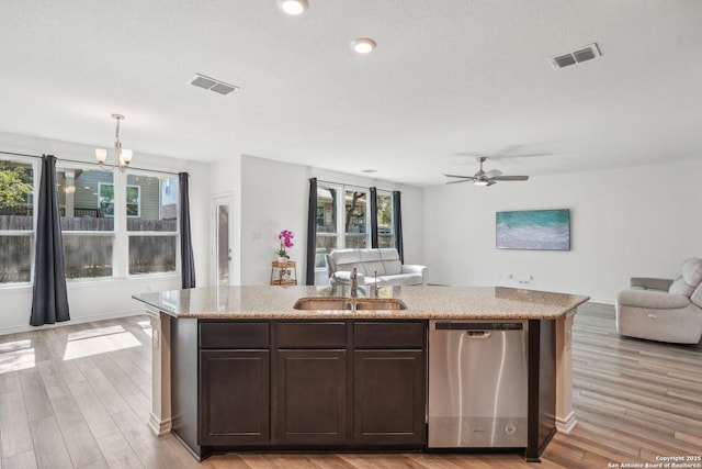 kitchen featuring a sink, open floor plan, stainless steel dishwasher, and visible vents