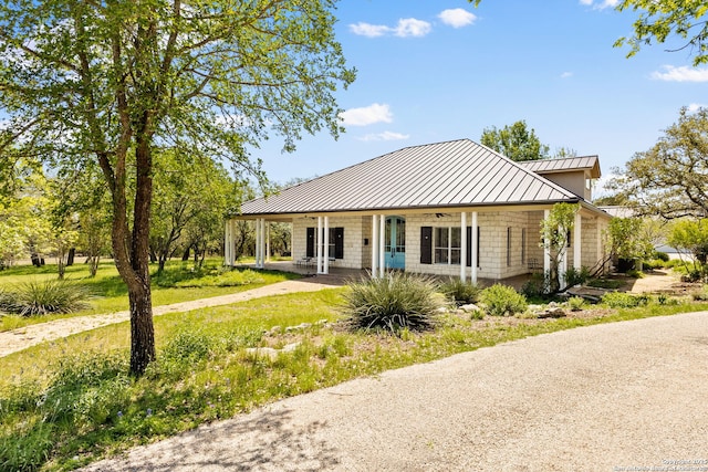 23954 Cibolo Vw, San Antonio, TX 78266 - view of front facade with metal roof, covered porch, and a standing seam roof