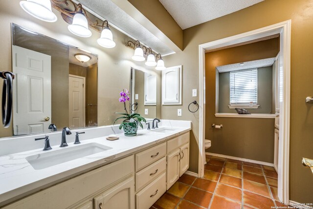 2910 Bee Cave, San Antonio, TX 78231 - full bathroom with toilet, double vanity, tile patterned floors, and baseboards