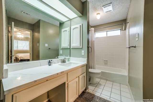 2910 Bee Cave, San Antonio, TX 78231 - ensuite bathroom featuring tile patterned floors, toilet, a textured ceiling, vanity, and shower / tub combo with curtain