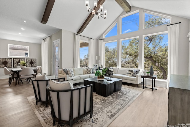 living area featuring an inviting chandelier, recessed lighting, light wood-style flooring, and beamed ceiling