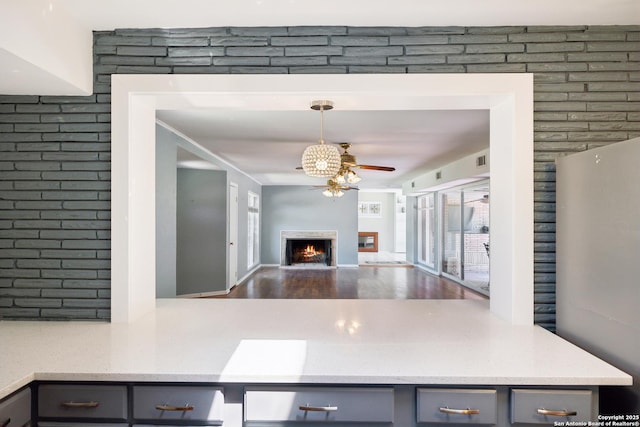 800 Eventide, Terrell Hills, TX 78209 - kitchen with ceiling fan, gray cabinets, a lit fireplace, wood finished floors, and open floor plan